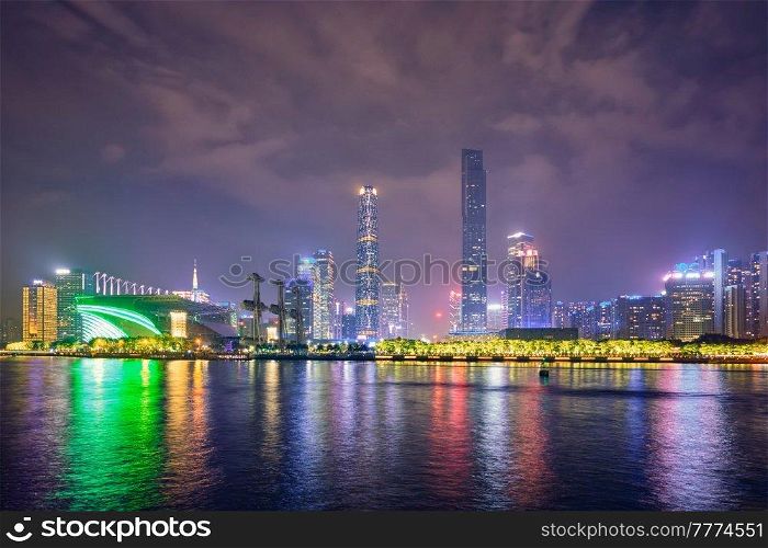 Guangzhou cityscape skyline over the Pearl River illuminated in the evening. Guangzhou, China. Guangzhou skyline. Guangzhou, China