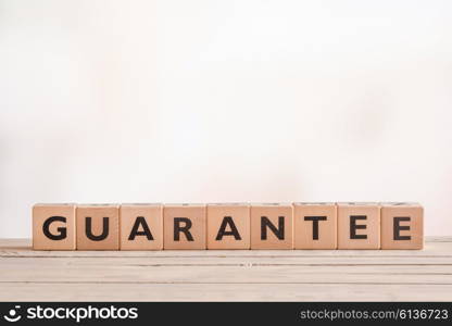 Guarantee sign made of blocks on a wooden desk