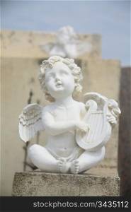 Guarding angel playing the harp on a cemetery in the Provence, France