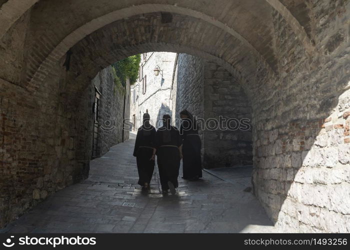 Gubbio, Perugia, Umbria, Italy: historic buildings of the medieval city. Three nuns