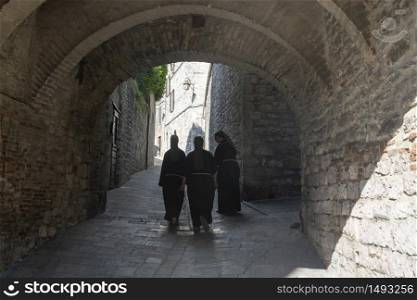 Gubbio, Perugia, Umbria, Italy: historic buildings of the medieval city. Three nuns