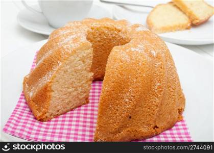 Guglhupf - Traditional Sponge Cake on Plate and Cup on Table
