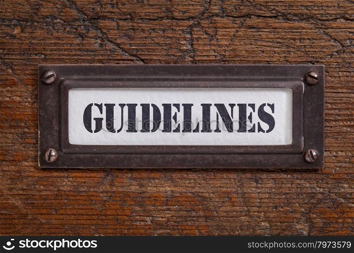 guidelines - file cabinet label, bronze holder against grunge and scratched wood