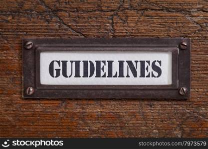 guidelines - file cabinet label, bronze holder against grunge and scratched wood