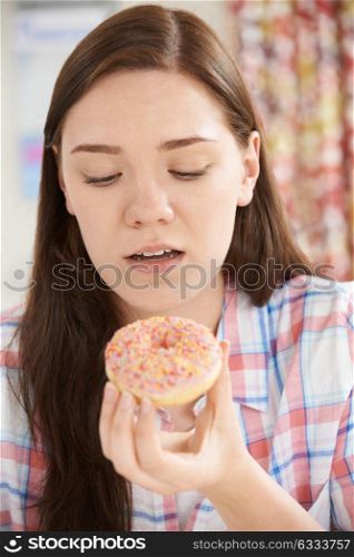 Guilty Looking Teenage Girl On Diet Eating Donut