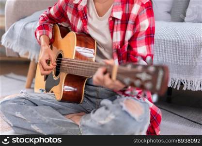 Guitar and singer concept, Young asian woman playing acoustic guitar after composing new song.