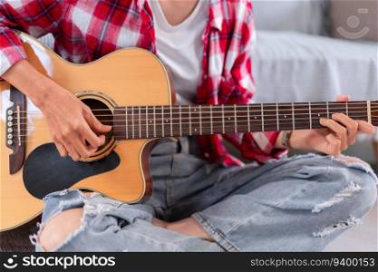 Guitar and singer concept, Young asian woman playing acoustic guitar after composing new song.