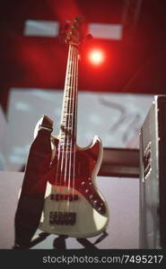 guitar at a concert on stage in the rays of light.