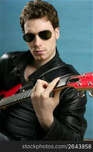 guitar rock star man sunglasses and leather perfect jacket over blue