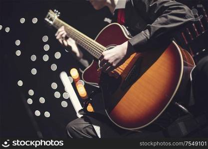 guitarist at a concert plays and sings