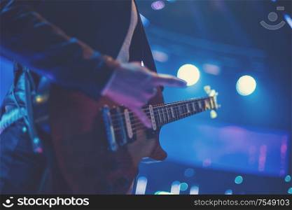 guitarist at a concert plays and sings