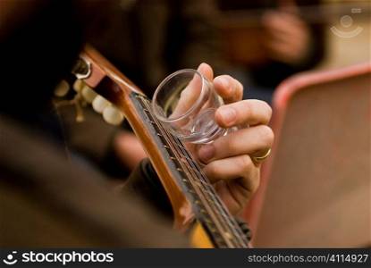 Guitarist holding empty glass