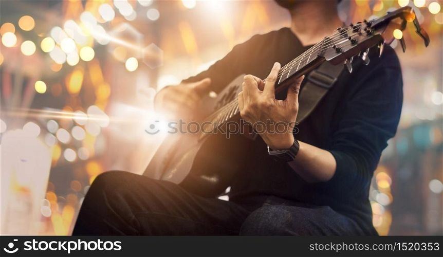 Guitarist on stage and sings at a concert for background, soft and blur concept