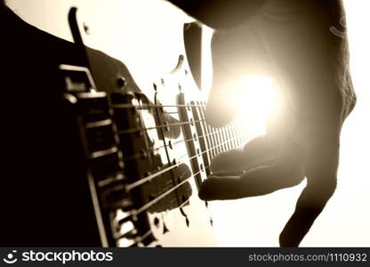 Guitarist plays on stage. Closeup view