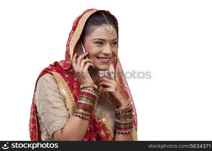 Gujarati bride talking on a mobile phone