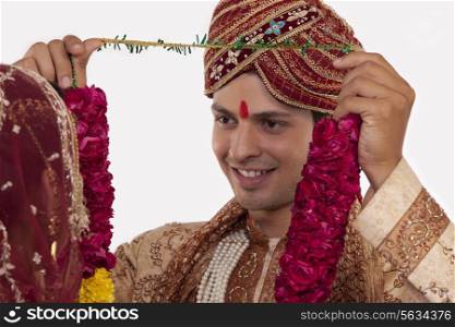 Gujarati groom putting a garland on a bride