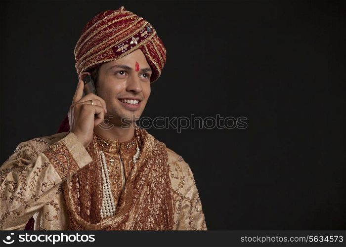 Gujarati groom talking on a mobile phone