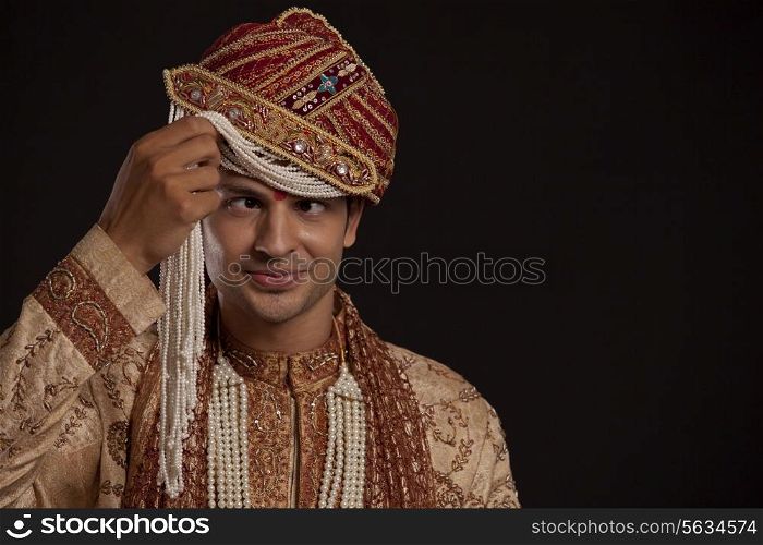 Gujarati groom with a headdress making a face