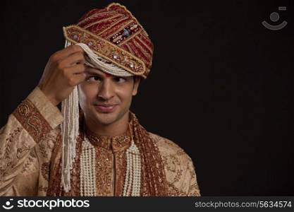 Gujarati groom with a headdress making a face