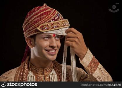 Gujarati groom with a headdress smiling