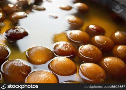 Gulab jamuns in syrup displayed at stall
