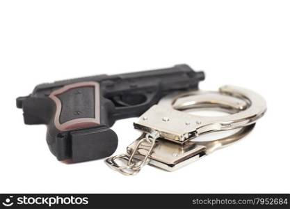 Gun and handcuffs isolated on white background