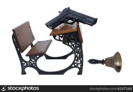 Gun on a Vintage wooden student desk with school bell - path included