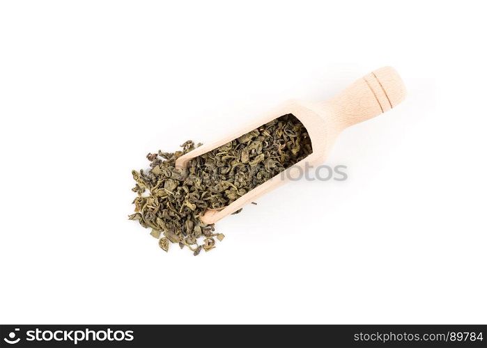 Gunpowder green tea in scoop isolated on a white background