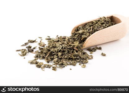 Gunpowder green tea in scoop isolated on a white background