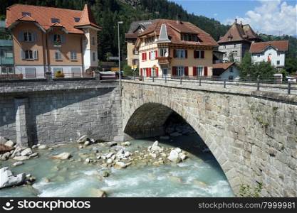 GURTNELLEN, SWITZERLAND - CIRCA AUGUST 2015 Bridge and houses near river