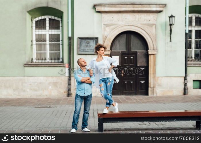 guy and a girl happily walk in the morning on the empty streets of old Europe