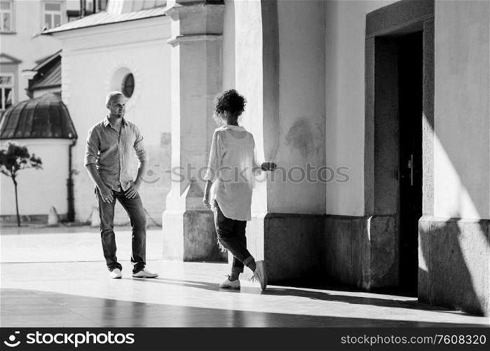 guy and a girl happily walk in the morning on the empty streets of old Europe