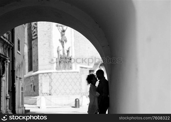guy and a girl happily walk in the morning on the empty streets of old Europe