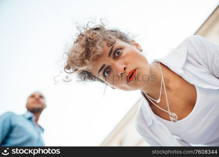 guy and a girl happily walk in the morning on the empty streets of old Europe