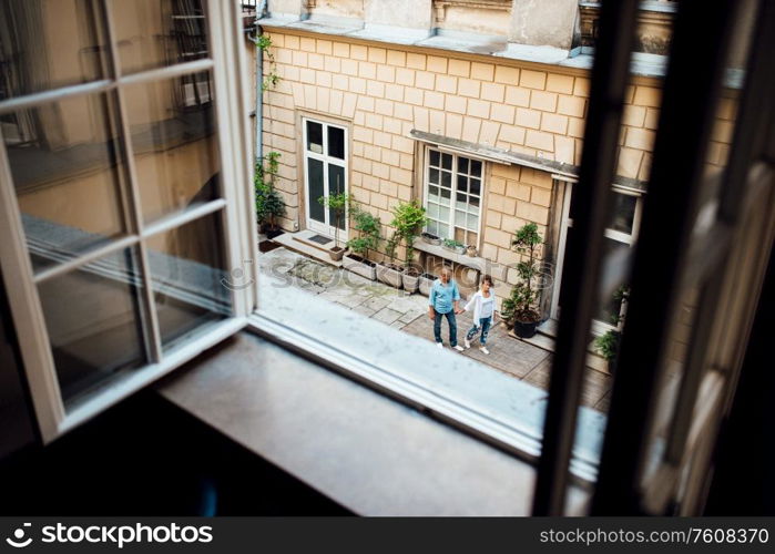 guy and a girl happily walk in the morning on the empty streets of old Europe