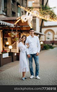 guy and a girl happily walk in the morning on the empty streets of old Europe