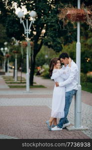 guy and a girl happily walk in the morning on the empty streets of old Europe