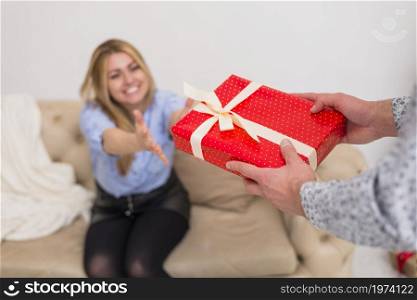 guy giving present young smiling lady settee