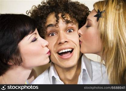 guy kissed by two attractive girls