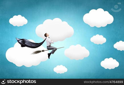 Guy on broom. Young businessman flying on broom high in sky