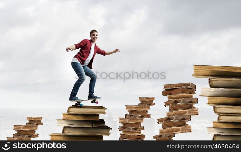 Guy on skateboard. Handsome teenager acive boy riding skateboard on books