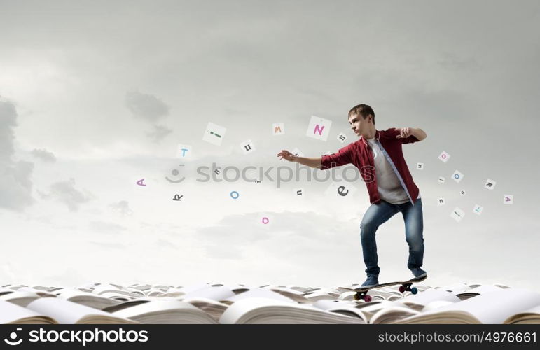 Guy on skateboard. Handsome teenager acive boy riding skateboard on books