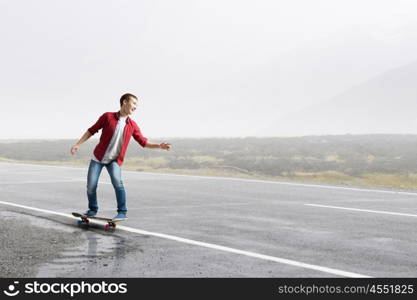 Guy on skateboard. Handsome teenager cool acive boy riding skateboard