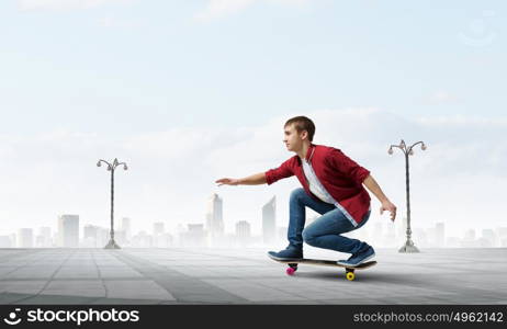 Guy on skateboard. Handsome teenager cool acive boy riding skateboard