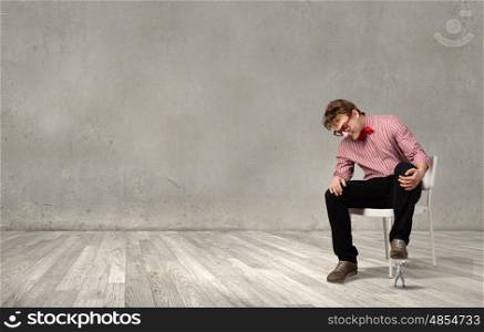 Guy sitting on chair and stepping on small business person. I will smash you