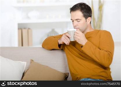 guy sniffing aroma of coffee