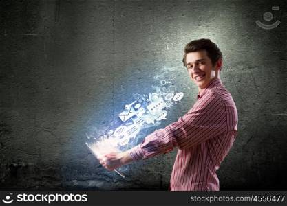 Guy using tablet pc. Young handsome smiling man using tablet pc