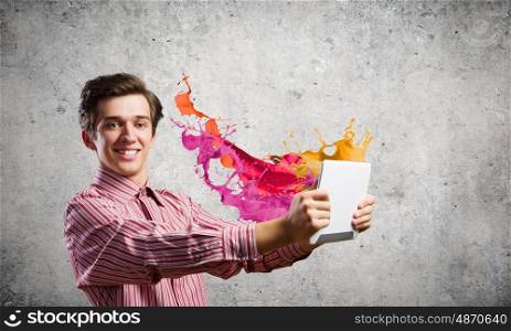 Guy using tablet pc. Young handsome smiling man using tablet pc