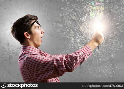 Guy using tablet pc. Young man looking shocked in tablet pc