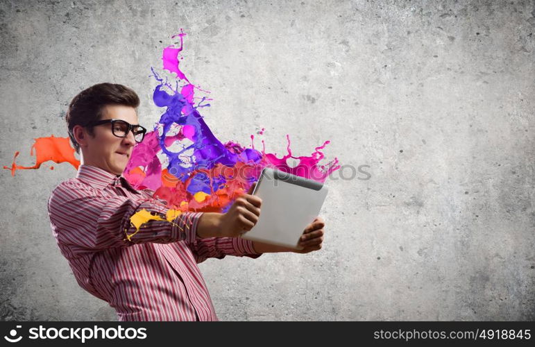 Guy using tablet pc. Young man looking shocked in tablet pc